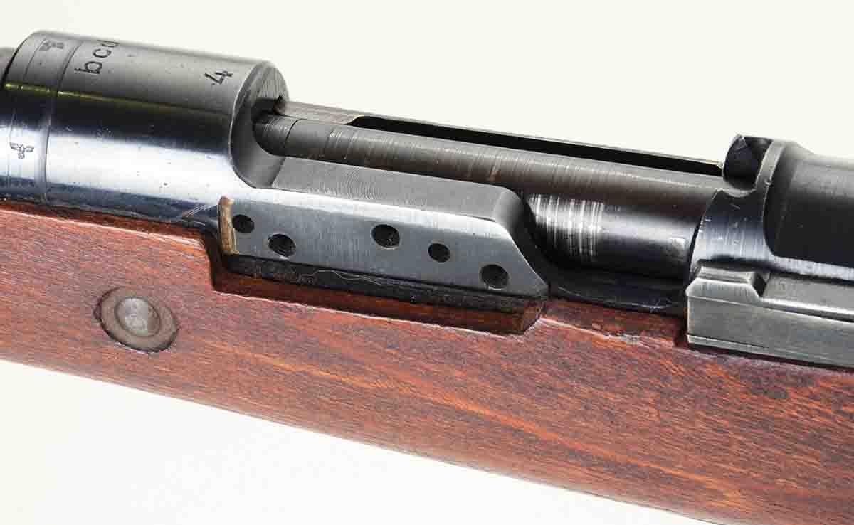 The left action side rail on this K98k, coded “bcd4,” was made 1⁄8 inch wider so it could be machined flat for mounting long side rail mounts more securely.